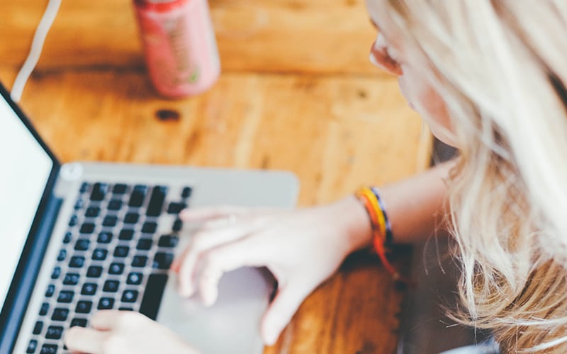 A closeup of a woman using a laptop