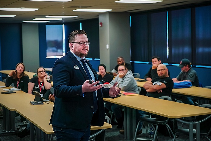 An instructor teaching business to a college class