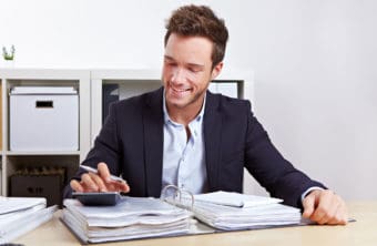 Young male is studying accounting in his office