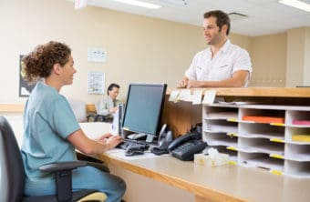 A female Health Administrature assisting a patient