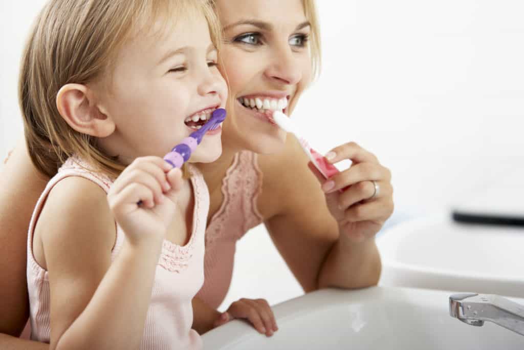 child brushing teeth