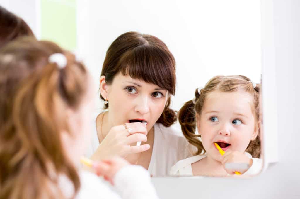 Kid and Parent Brushing Teeth